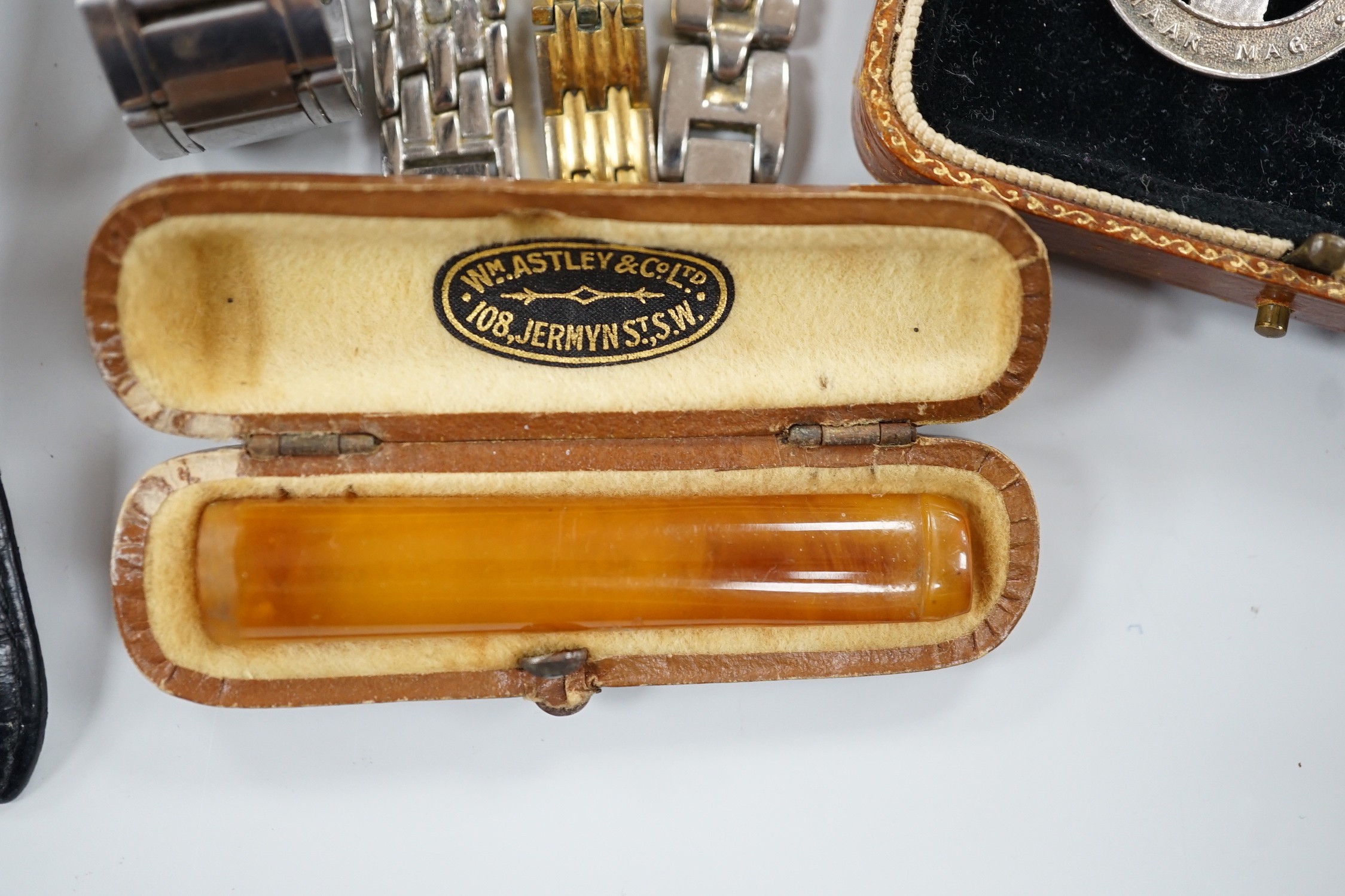 Seven assorted modern wrist watches including Pulsar and Rotary, a 9ct and 'silver' eternity ring, a case amber cigarette holder and two white metal brooches, including one with enamel.